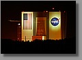 Vehicle Assembly Building. The two lights streaks are from a passing helicopter.