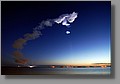 As sunrise approached, the upper portions of the plume began to glow. Very pretty. If you look closely, you can still see the streak of Discovery just above the horizon, right of center.