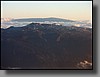 Mauna Kea (13,796 ft.) is the home to approximately twenty of the world's most powerful telescopes.  The summit is commonly above cloud bases, which makes for clear stargazing.