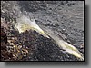 Hazardous volcanic fumes condense into yellow sulfur around active vents.